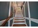 Beautiful staircase with wood steps, white risers and trim and a wood handrail at 1013 Canyon Point Cir, Roswell, GA 30076