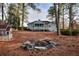 Backyard view of house and fire pit area and playhouse for children at 4020 Winchester Way, Loganville, GA 30052