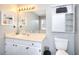 Bathroom with light wood cabinets, decorative mirror, and sink with open lighting at 4020 Winchester Way, Loganville, GA 30052