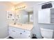 Bathroom with light wood cabinets, decorative mirror, and sink with open lighting at 4020 Winchester Way, Loganville, GA 30052
