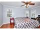 Spacious bedroom with wood floors, ceiling fan, natural light and light blue walls at 4020 Winchester Way, Loganville, GA 30052