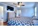 Spacious bedroom with wood floors, ceiling fan, natural light, TV, and walk in closet at 4020 Winchester Way, Loganville, GA 30052