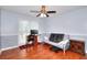 Bedroom features hardwood floors, a ceiling fan, and a futon at 4020 Winchester Way, Loganville, GA 30052
