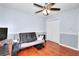 Bedroom features hardwood floors, a ceiling fan, and a futon at 4020 Winchester Way, Loganville, GA 30052