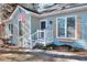 Charming light blue home with decorative window shutters and a welcoming front porch entrance at 4020 Winchester Way, Loganville, GA 30052