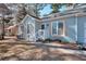 Charming light blue home with decorative window shutters and a welcoming front porch entrance at 4020 Winchester Way, Loganville, GA 30052