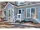Charming light blue home with decorative window shutters and a welcoming front porch entrance at 4020 Winchester Way, Loganville, GA 30052