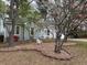 Charming exterior view features flowering trees and a well-maintained landscape at 4020 Winchester Way, Loganville, GA 30052