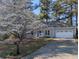 Well-maintained home featuring a beautiful tree and a two-car garage at 4020 Winchester Way, Loganville, GA 30052