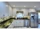 Updated kitchen with stainless steel appliances and black countertops at 4020 Winchester Way, Loganville, GA 30052