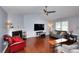 Cozy living room with a brick fireplace, hardwood floors, and comfortable seating at 4020 Winchester Way, Loganville, GA 30052