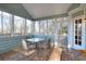 Enclosed sunroom with tongue and groove walls and ceiling, and wood flooring at 4020 Winchester Way, Loganville, GA 30052