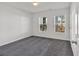 Bedroom featuring gray carpeting, white walls, and two windows with blinds at 629 Everett Ln, Woodstock, GA 30188