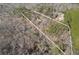 Aerial view of the property lines and the home nestled amongst the trees at 218 Sutallee Ridge Ne Ct, White, GA 30184