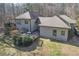 Aerial shot showcases the home's decks, landscaping, green spaces, and the home's exterior architecture at 218 Sutallee Ridge Ne Ct, White, GA 30184