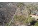 Aerial view of the property lines and the charming home nestled amongst the trees at 218 Sutallee Ridge Ne Ct, White, GA 30184