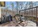 Wooden back deck features a table with chairs and a grill, perfect for relaxing and entertaining outdoors at 218 Sutallee Ridge Ne Ct, White, GA 30184