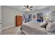 Bedroom featuring neutral walls, carpet, ceiling fan, and two large windows that let in plenty of natural light at 218 Sutallee Ridge Ne Ct, White, GA 30184