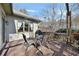 Outdoor deck featuring a table, chairs, grill, and serene wooded view, perfect for relaxing and entertaining at 218 Sutallee Ridge Ne Ct, White, GA 30184