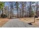 Home's long gravel driveway with a mailbox at the end at 218 Sutallee Ridge Ne Ct, White, GA 30184