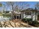 Beautiful home exterior with a lush front yard and a cozy pergola leading to the entrance at 218 Sutallee Ridge Ne Ct, White, GA 30184