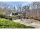 Attractive home with a long driveway and a three-car garage nestled in a serene, wooded neighborhood at 218 Sutallee Ridge Ne Ct, White, GA 30184