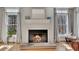 Close-up of a cozy fireplace with white mantle and hearth, with natural light from nearby windows at 218 Sutallee Ridge Ne Ct, White, GA 30184