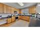 Bright kitchen with stainless steel appliances, ample counter space, and natural wood cabinets at 218 Sutallee Ridge Ne Ct, White, GA 30184