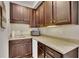 Kitchenette featuring dark wood cabinets, light countertops, microwave, mini fridge, and stainless steel sink at 218 Sutallee Ridge Ne Ct, White, GA 30184