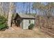 A shed in the backyard, constructed with a durable roof, providing additional storage space and backyard functionality at 218 Sutallee Ridge Ne Ct, White, GA 30184