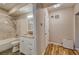 Well-lit bathroom featuring a tiled shower, vanity with storage, and modern fixtures at 2300 Kate Moore Way, Buford, GA 30518