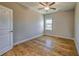 This bedroom features beautiful hardwood floors, a ceiling fan, and neutral walls at 2300 Kate Moore Way, Buford, GA 30518