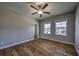 Bright bedroom featuring two large windows providing natural light and neighborhood views at 2300 Kate Moore Way, Buford, GA 30518