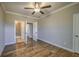 Bedroom features hardwood floors, neutral paint, white trim, and an ensuite bathroom at 2300 Kate Moore Way, Buford, GA 30518