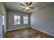 This bedroom features hardwood floors, two windows that offer natural light, and neutral walls at 2300 Kate Moore Way, Buford, GA 30518