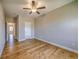 Bedroom showcasing hardwood floors, ceiling fan and neutral walls at 2300 Kate Moore Way, Buford, GA 30518