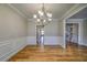 Dining room with hardwood floors, wainscoting, and views of the pantry and staircase at 2300 Kate Moore Way, Buford, GA 30518