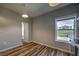 Bright dining room with hardwood floors, modern light fixture, and window with a view of the outdoors at 2300 Kate Moore Way, Buford, GA 30518