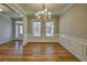 Dining area featuring hardwood floors, wainscoting, and a view into the foyer at 2300 Kate Moore Way, Buford, GA 30518