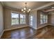 Sunlit dining area with hardwood floors and an elegant chandelier at 2300 Kate Moore Way, Buford, GA 30518