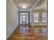 Bright foyer with hardwood floors, a front door with sidelights, and views into another room at 2300 Kate Moore Way, Buford, GA 30518