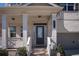 Inviting front porch with columns, brick accents, and stairs leading to the main entrance, number 2300 is visible at 2300 Kate Moore Way, Buford, GA 30518