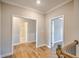 Bright hallway showcasing hardwood floors and white trim leading to various rooms at 2300 Kate Moore Way, Buford, GA 30518