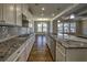 Spacious kitchen featuring granite countertops, stainless appliances, and a tile backsplash at 2300 Kate Moore Way, Buford, GA 30518