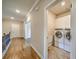 Hallway view to the laundry room featuring a washer and dryer at 2300 Kate Moore Way, Buford, GA 30518