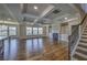 Bright living room with hardwood floors, coffered ceilings, fireplace, and a staircase at 2300 Kate Moore Way, Buford, GA 30518