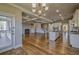 Open floor plan boasts a large kitchen island, hardwood floors and a view of the coffered ceilings at 2300 Kate Moore Way, Buford, GA 30518