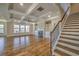 Bright living room with hardwood floors, coffered ceilings, fireplace, and a staircase at 2300 Kate Moore Way, Buford, GA 30518