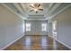 Spacious main bedroom features hardwood floors, two windows, and trey ceiling with ceiling fan at 2300 Kate Moore Way, Buford, GA 30518