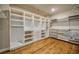 Spacious walk-in closet with hardwood floors, shelving and closet rods at 2300 Kate Moore Way, Buford, GA 30518